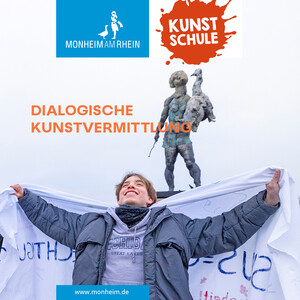 Deckblatt der Broschüre zum Rückblick 2025. Eine Person steht mit ausgebreiteten Armen und fröhlichem Gesichtsausdruck vor einer Statue im öffentlichen Raum. Das Bild ist clickbar, die Broschüre dahinter barrierefrei.